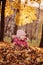 Vertical portrait of cute smiling child girl having fun on the sunny autumn walk