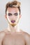 Vertical portrait of cutie young gay model with makeup and multi