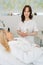 Vertical portrait of female cosmetologist holding on hand electrical equipment for vacuum facial massage therapy