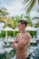 Vertical portrait of handsome man in the swimming pool at the tropical island luxury resort