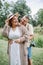 Vertical portrait of happy laughing married couple on summer day in nature. Harmonious family.