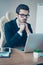 Vertical portrait of minded entrepreneur in spectacles holding