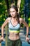 vertical portrait of a muscular woman posing at the gym in the park during