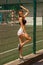 Vertical portrait slender sport girl at the stadium