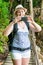 vertical portrait of a tourist with a phone and a backpack