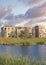 Vertical Puffy clouds at sunset Oquirrh Lake at the front of residential complex buildings at Da