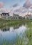 Vertical Puffy clouds at sunset Oquirrh Lake with a reflection of the residential houses at Dayb