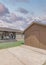 Vertical Puffy clouds at sunset Small wooden shed exterior with a concrete pad flooring