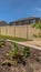 Vertical Raised garden beds with plants and soil at the backyard with gravel and grasses