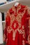 Vertical of a red luxurious dress with intricate gold embroidery