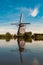 Vertical of reflection of a windmill at Kinderdijk, UNESCO heritage museum on a scenic mirror lake