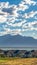 Vertical Residential area with scenic view of lake and mountain under cloudy blue sky