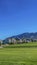 Vertical Residential area on a valley with view of mountain under blue sky and bright sun