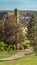 Vertical Residential scenery with pathways and grassy field in front of charming houses