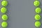 Vertical rows of tennis balls on gray background. International championship