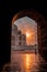 Vertical of a scenic view of the Taj Mahal Mausoleum at sunset through the archway of the mosque