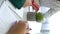 Vertical Screen: closeup student hands with pens and notebooks on table