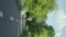 Vertical Screen: Woman jogging in summer park in slow motion