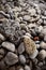 Vertical sea beach textured surface stones background