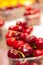 Vertical selective focus shot of fresh vibrant cherries in plastic containers