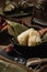 Vertical selective focus shot of preparation of rice dumplings with banana leaves