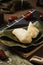 Vertical selective focus shot of preparation of rice dumplings with banana leaves