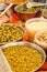 Vertical selective focus shot of a variety of pickled vegetables in the market