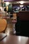 Vertical selective shoot of round stools and brown chairs in a bar