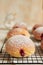 Vertical shallow focus closeup of buns with Marmelade and sugar powder