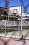 Vertical shoot of basketball hall behind metal fences