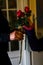 Vertical shot of an aged female giving two red roses to another one at a funeral