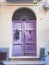 Vertical shot of an ancient purple door - great for a cool background or wallpaper