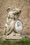 Vertical shot of an angel statue with an image of Christ and a blurred background