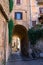 Vertical shot of an arch under a residential building in Italy