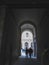 Vertical shot of an arched pathway with people walking in Florence, Italy