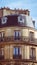 Vertical shot of an architectural building facade with chimneys