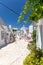 Vertical shot of architectures with cone roofs made of small stones in Alberobello, Italy