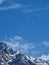 Vertical shot of an awe-inspiring mountain range, with majestic snow-capped peaks rising to the sky