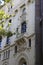 Vertical shot of balconies of buildings decorated with engravings in Madrid, Spain