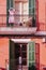 Vertical shot of the balconies of a residential building with an orange facade