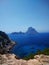 Vertical shot of the beach next to Ibiza and Es Vedra in the background