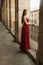 Vertical shot of a beautiful caucasian woman in a red gala dress, portrait before going to the party