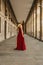 Vertical shot of a beautiful caucasian woman in a red gala dress, portrait before going to the party