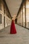 Vertical shot of a beautiful caucasian woman in a red gala dress, portrait before going to the party