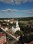 Vertical shot of a beautiful cloudscape over a rural town cityscape with a view of Orthodox church