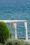 Vertical shot of a beautiful glass viewpoint towards the open sea on a bright day