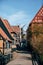 Vertical shot of the beautiful houses on the pavement captured in Den Gamle By, Aarhus, Denmark
