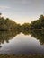 Vertical shot of a beautiful lake with the reflection of the trees that surrounds it on the water