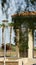 Vertical shot of beautiful park with mediterranean traditional patio and palm trees in sunny day