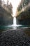 Vertical shot of a beautiful powerful waterfall in a forest during daytime